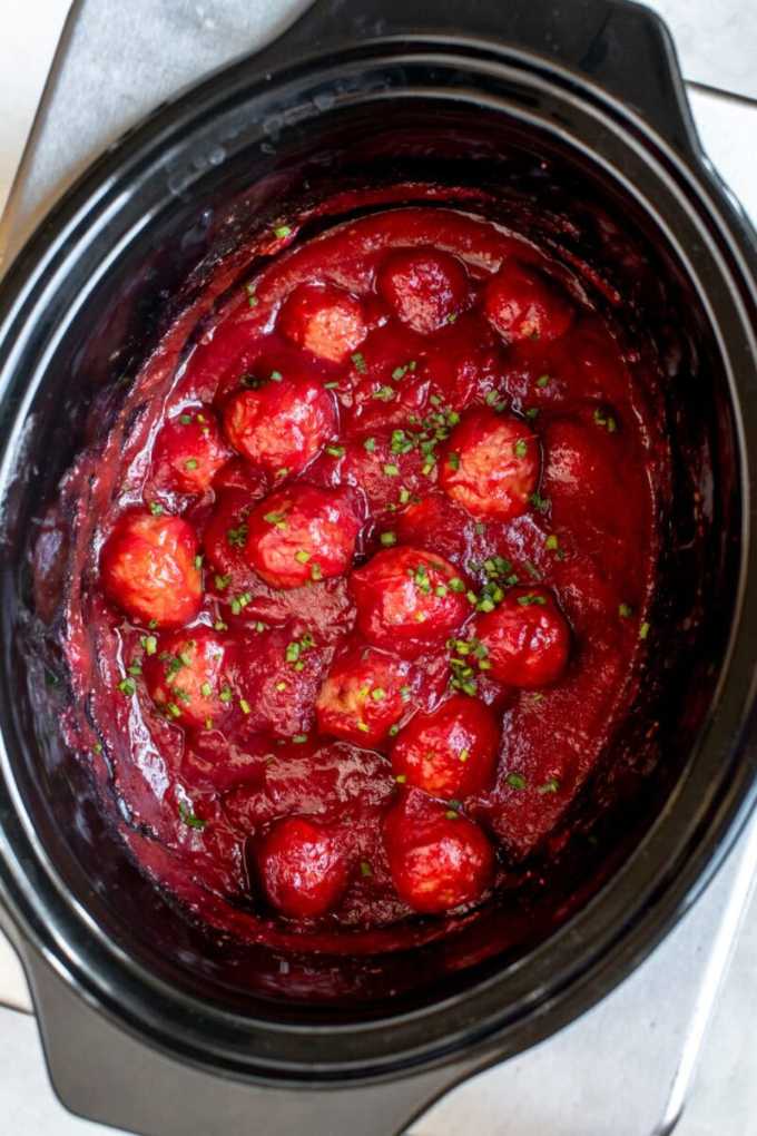 Juicy meatballs glazed in a glossy cranberry cocktail sauce, garnished with fresh parsley