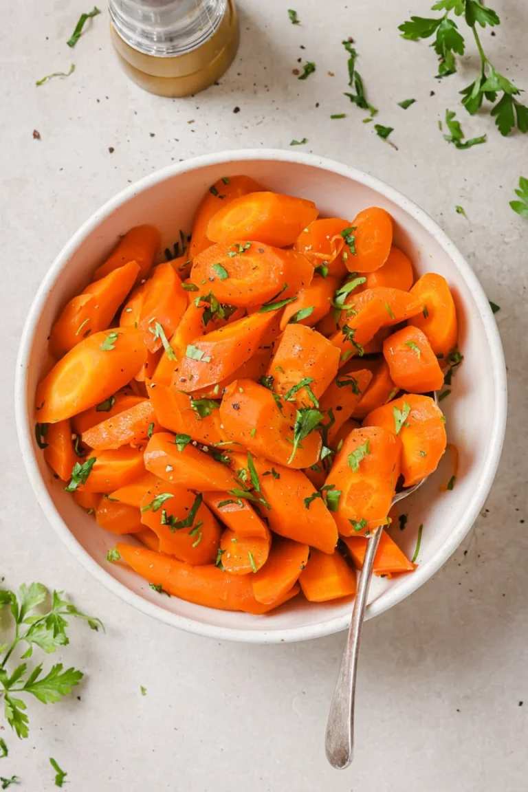 Tender baby carrots coated in a glossy honey glaze, sprinkled with fresh thyme