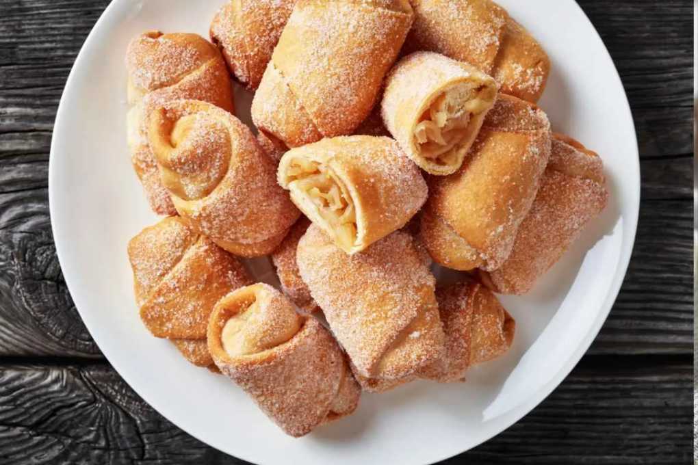 Golden crescent pastries filled with spiced apple pie filling, dusted with cinnamon sugar