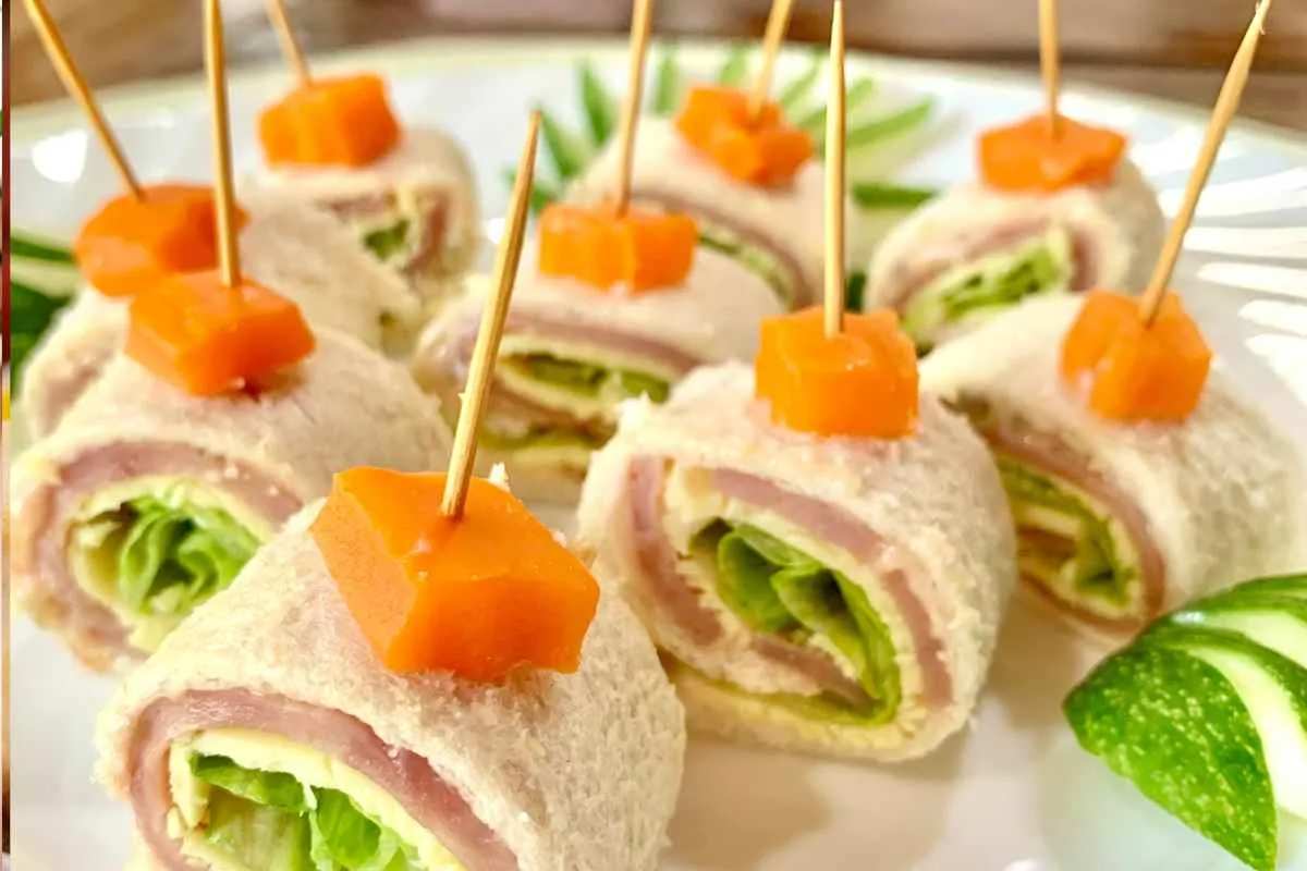 Colorful pinwheel sandwiches sliced and threaded on skewers with ham and cheese