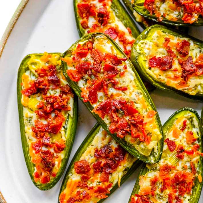 Jalapeño halves stuffed with cheddar, wrapped in crispy bacon, baked to perfection