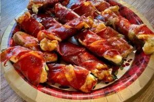 Jalapeño halves filled with cheese, wrapped in crisp prosciutto slices