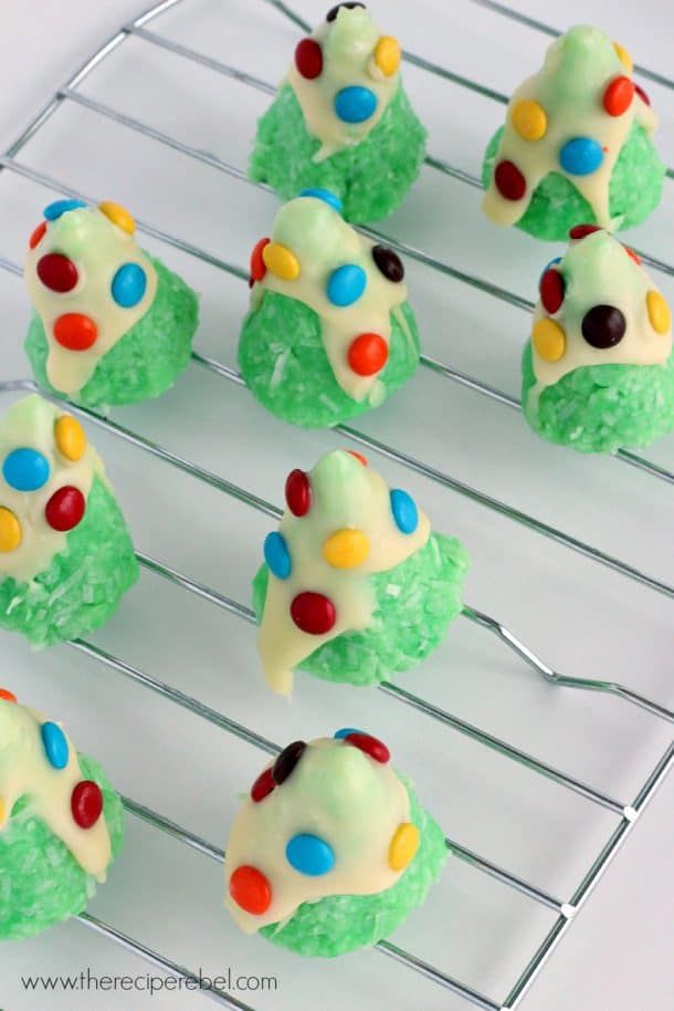 Small coconut clusters shaped like tiny Christmas trees, dusted with powdered sugar