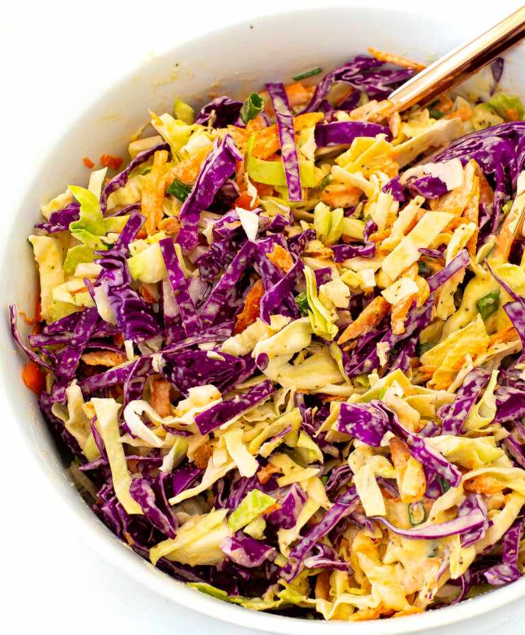 Tangy classic creamy coleslaw with crisp cabbage shreds in rich creamy dressing cool crunch.