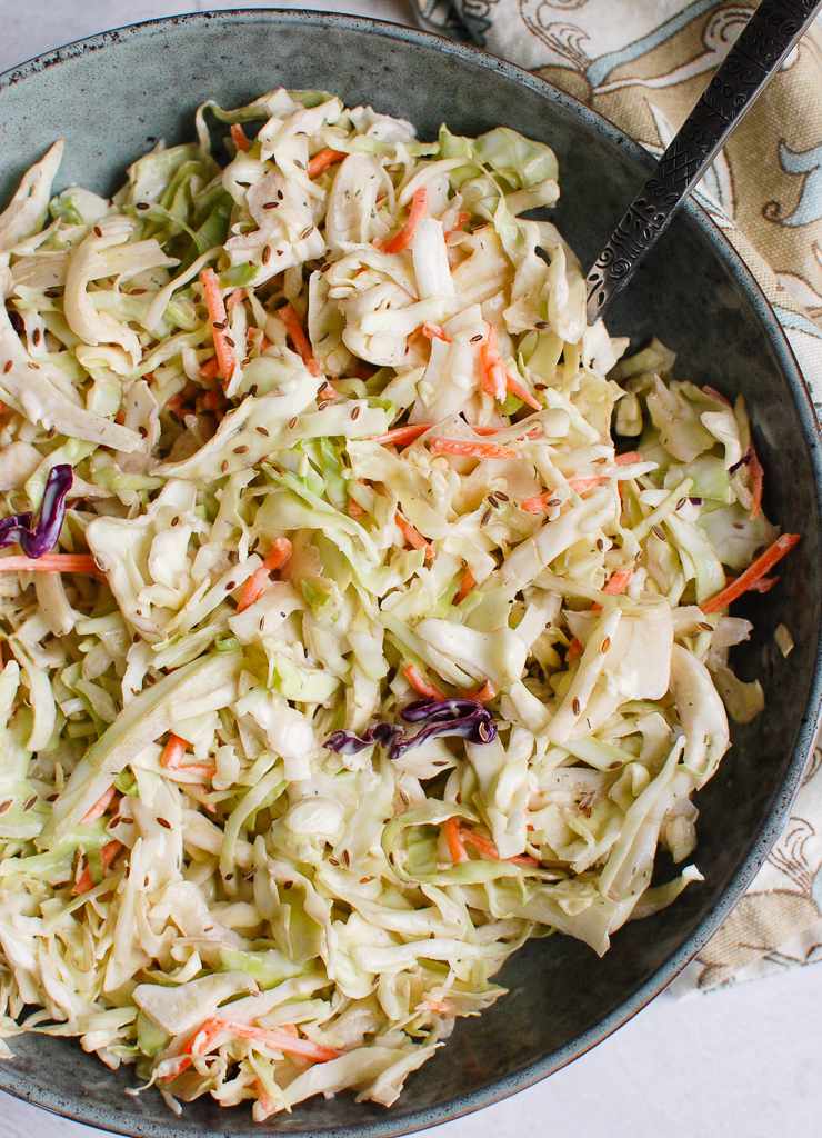 Sweet tangy creamy coleslaw highlighting crisp cabbage, smooth dressing, and refreshing cool crunch.
