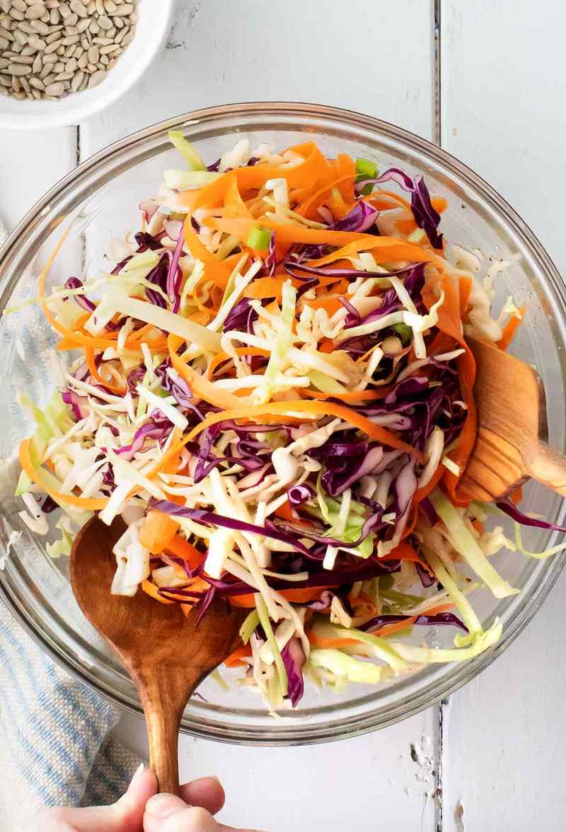 Classic vinegar slaw with crisp cabbage, sharp tang, and a light, refreshing finish