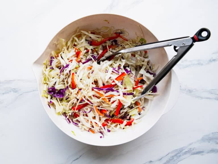 Bright vinegar coleslaw with crisp cabbage, tangy dressing, and fresh carrot ribbons