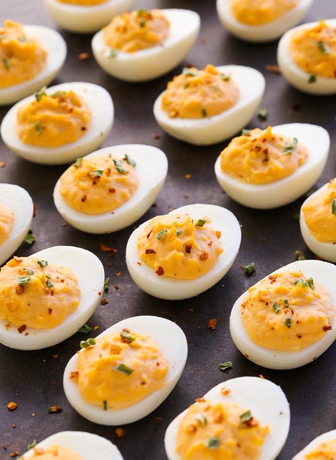 Jalapeño deviled eggs, creamy yolk, diced jalapeños, lime juice, cilantro, paprika dust