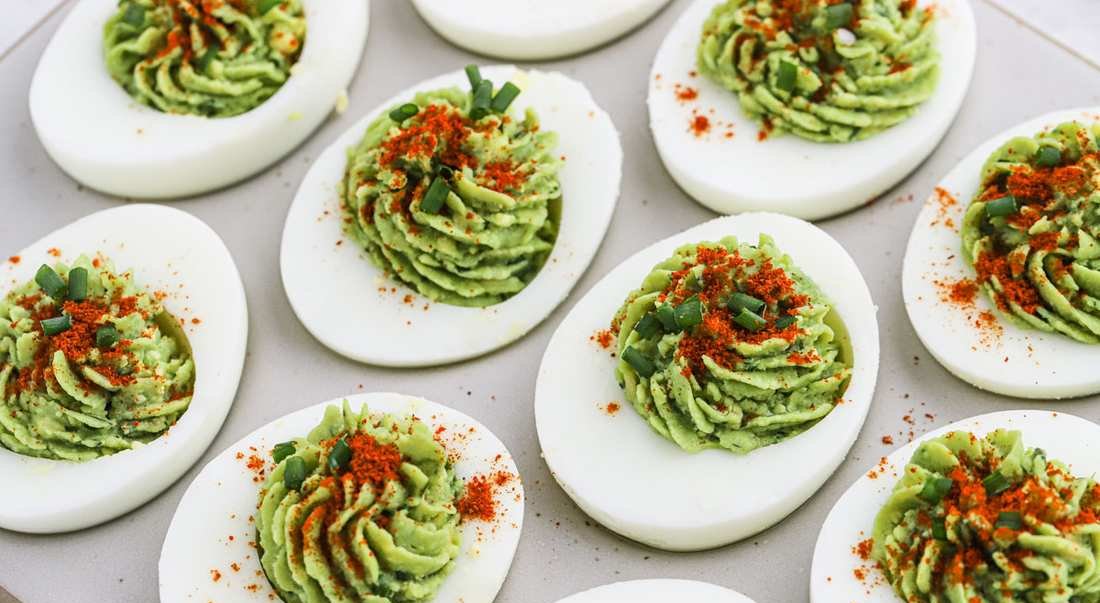 Avocado deviled eggs with cilantro, lime zest, and a sprinkle of paprika