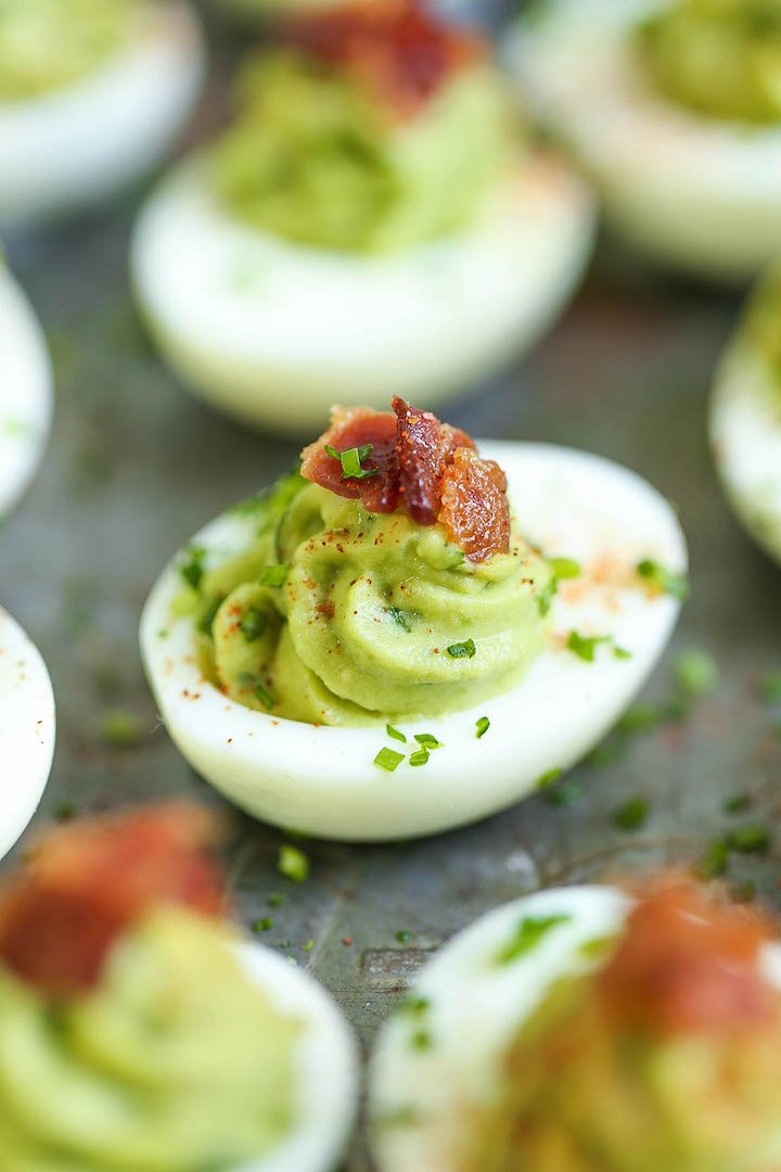 Avocado deviled eggs spiced with chipotle, topped with paprika and chives