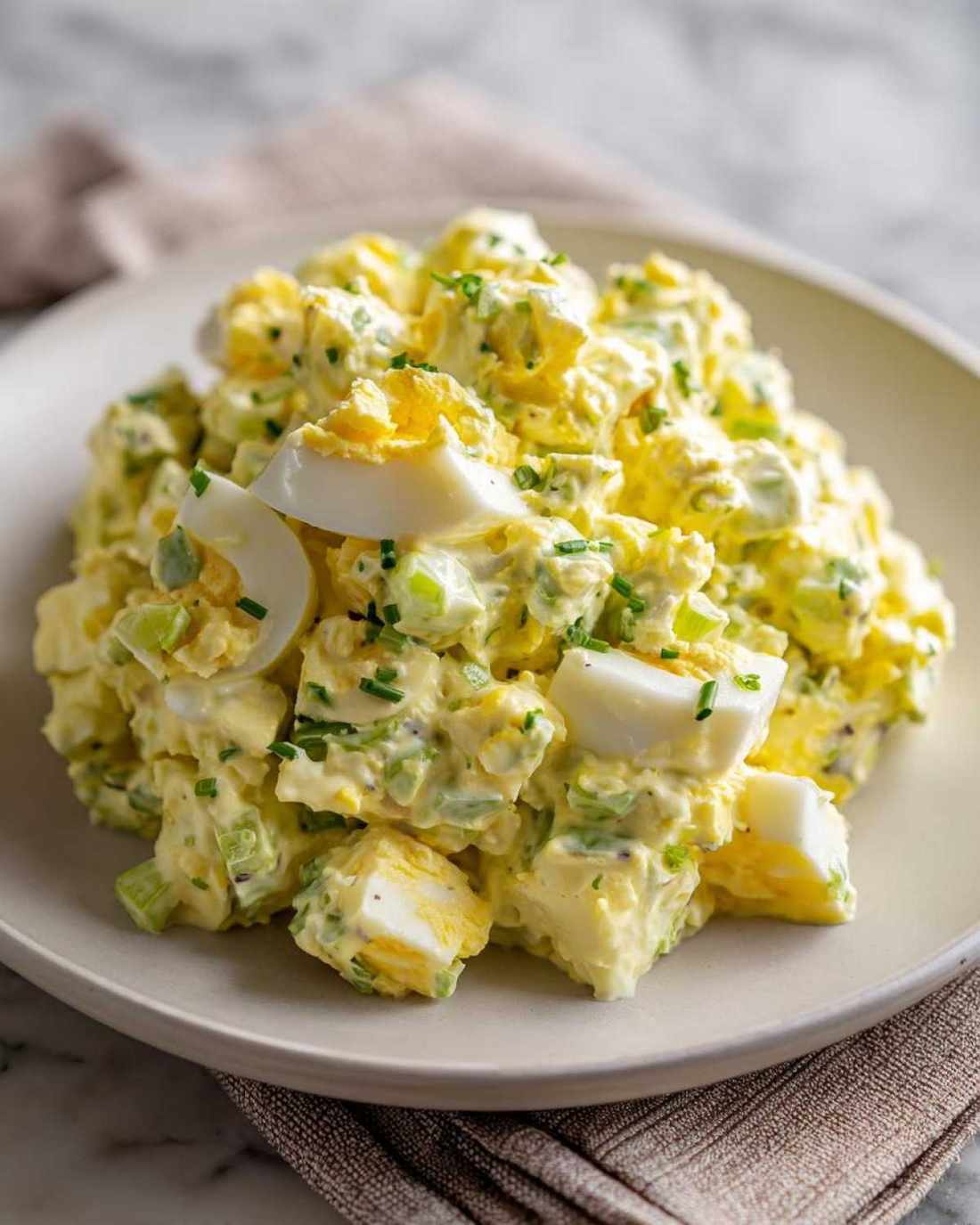 Classic creamy egg salad with chopped hard-boiled eggs, rich mayo, chives, and a hint of paprika