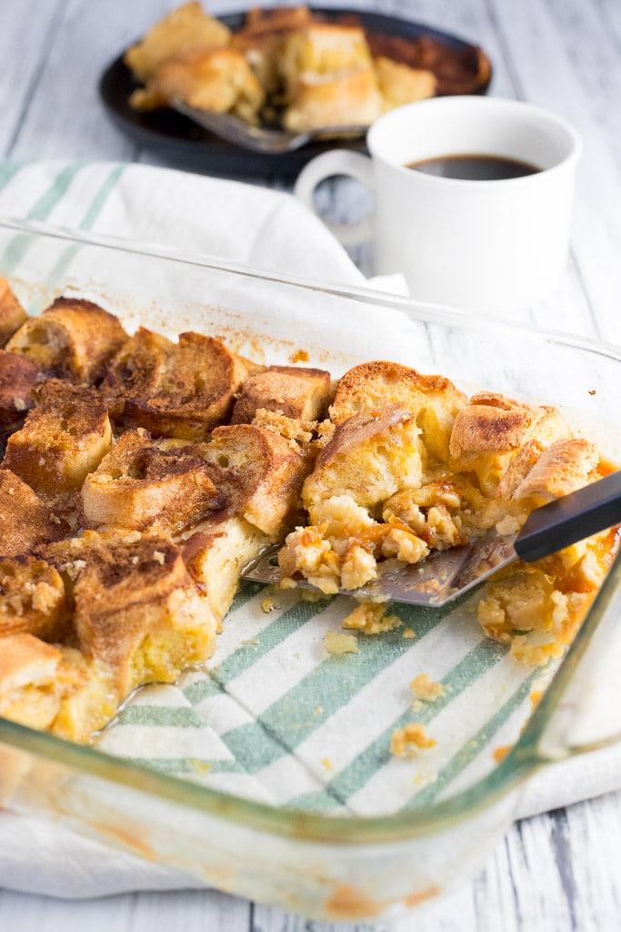 Golden baked French toast casserole cubes soaked in vanilla custard, dotted with berries