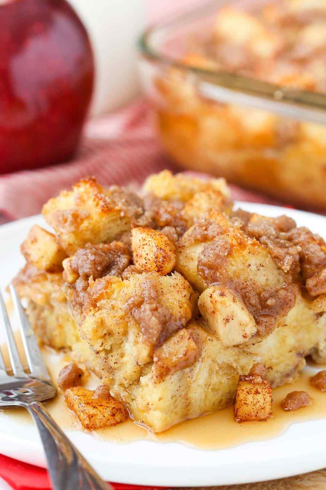Golden custardy bread cubes with warm apple slices, cinnamon, and a drizzle of maple syrup