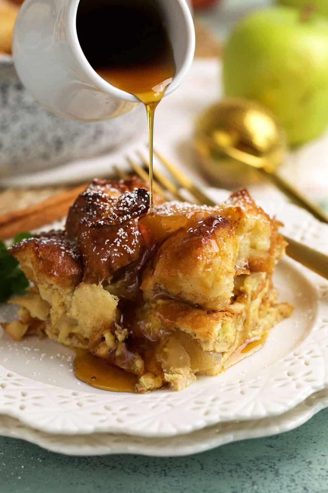 Golden custardy bread cubes layered with warm apple cinnamon, topped with a drizzle of maple syrup