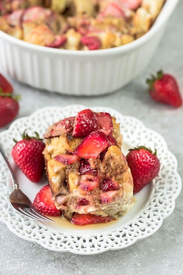 Strawberry berry french toast casserole with golden custardy bread cubes, warm berries, and a drizzle of maple syrup