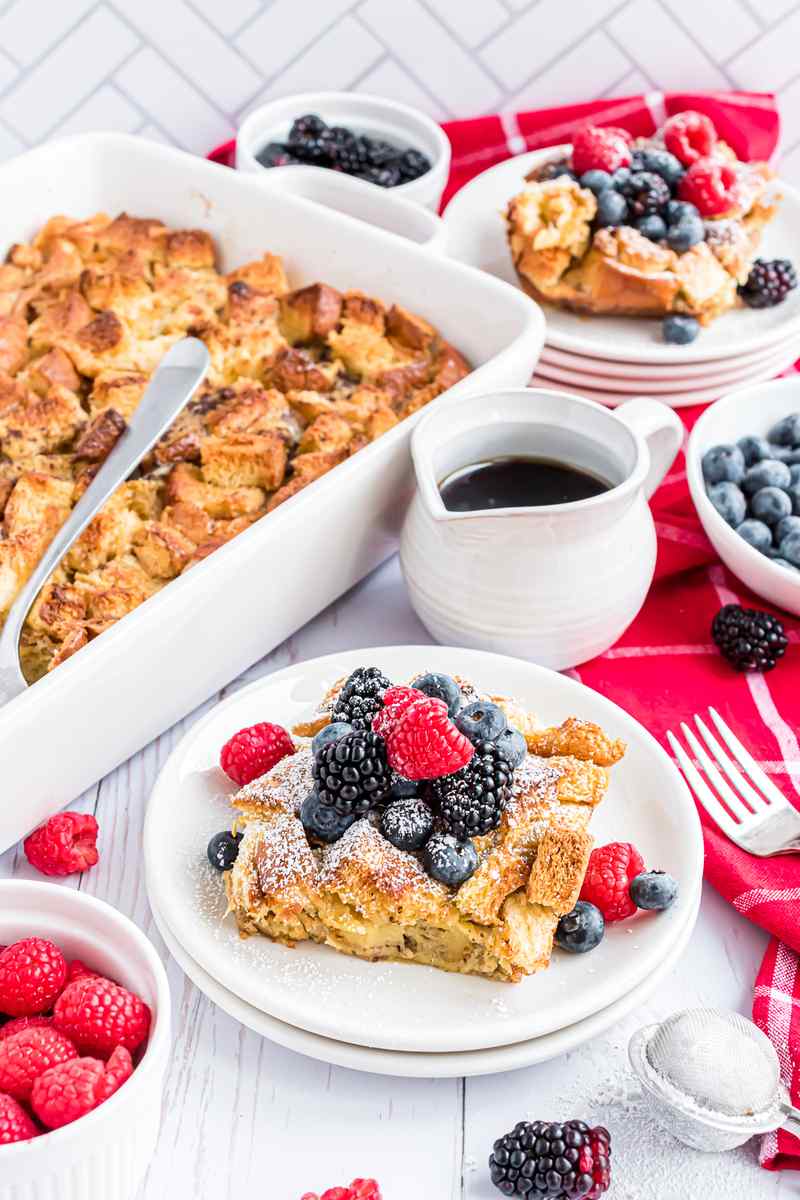 Rich, golden custardy brioche cubes topped with caramelized butter, served with fresh berries