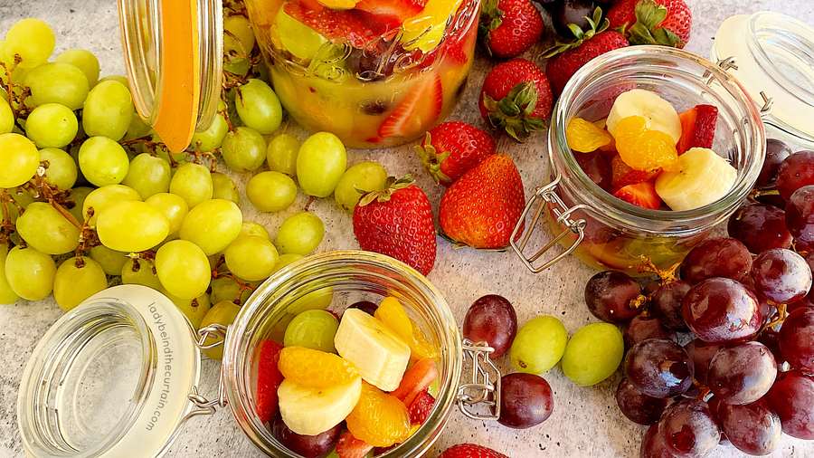 Classic fresh fruit salad with mixed berries, citrus wedges, and a light honey‑mint dressing