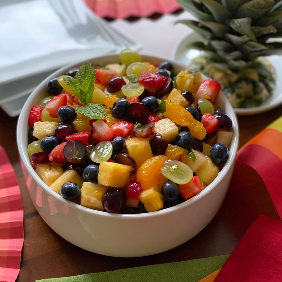 Autumn rainbow fruit salad with apples, pomegranate, grapes, and a warm apple cider glaze