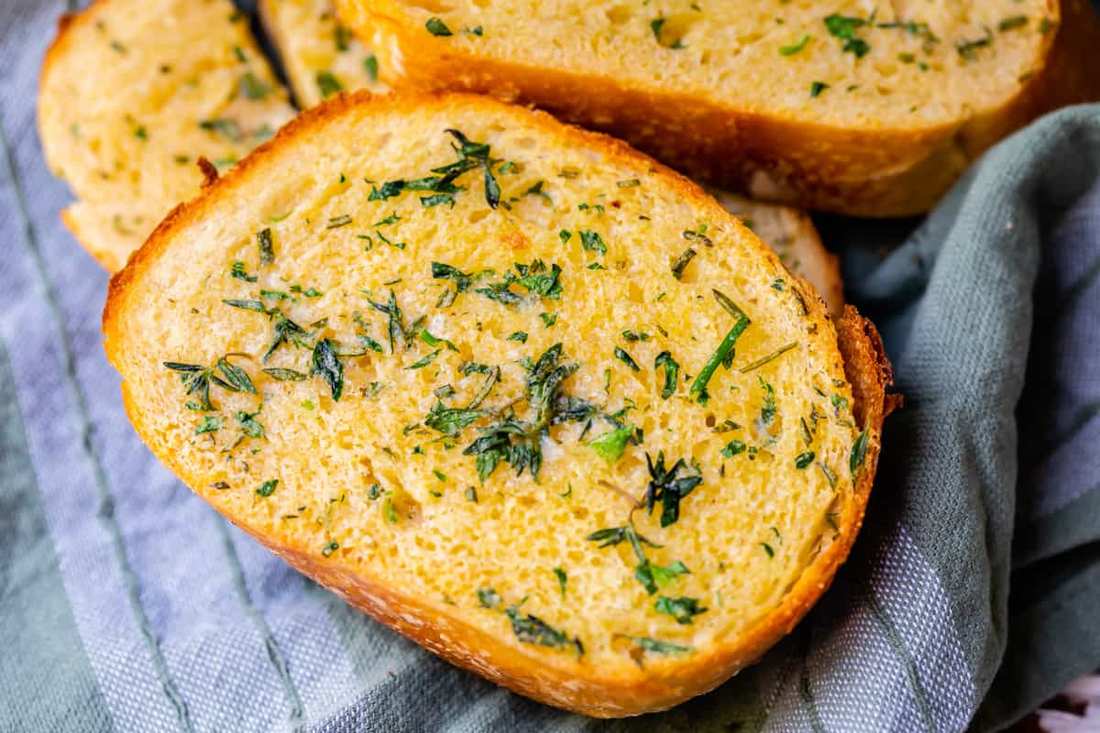Sourdough garlic bread with herb butter, crunchy crust, and aromatic garlic
