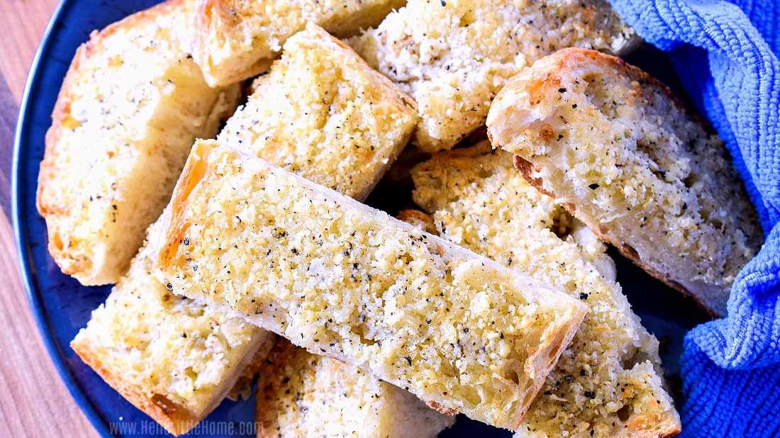 Classic garlic bread with golden crust, melted mozzarella, fragrant garlic, and parsley garnish
