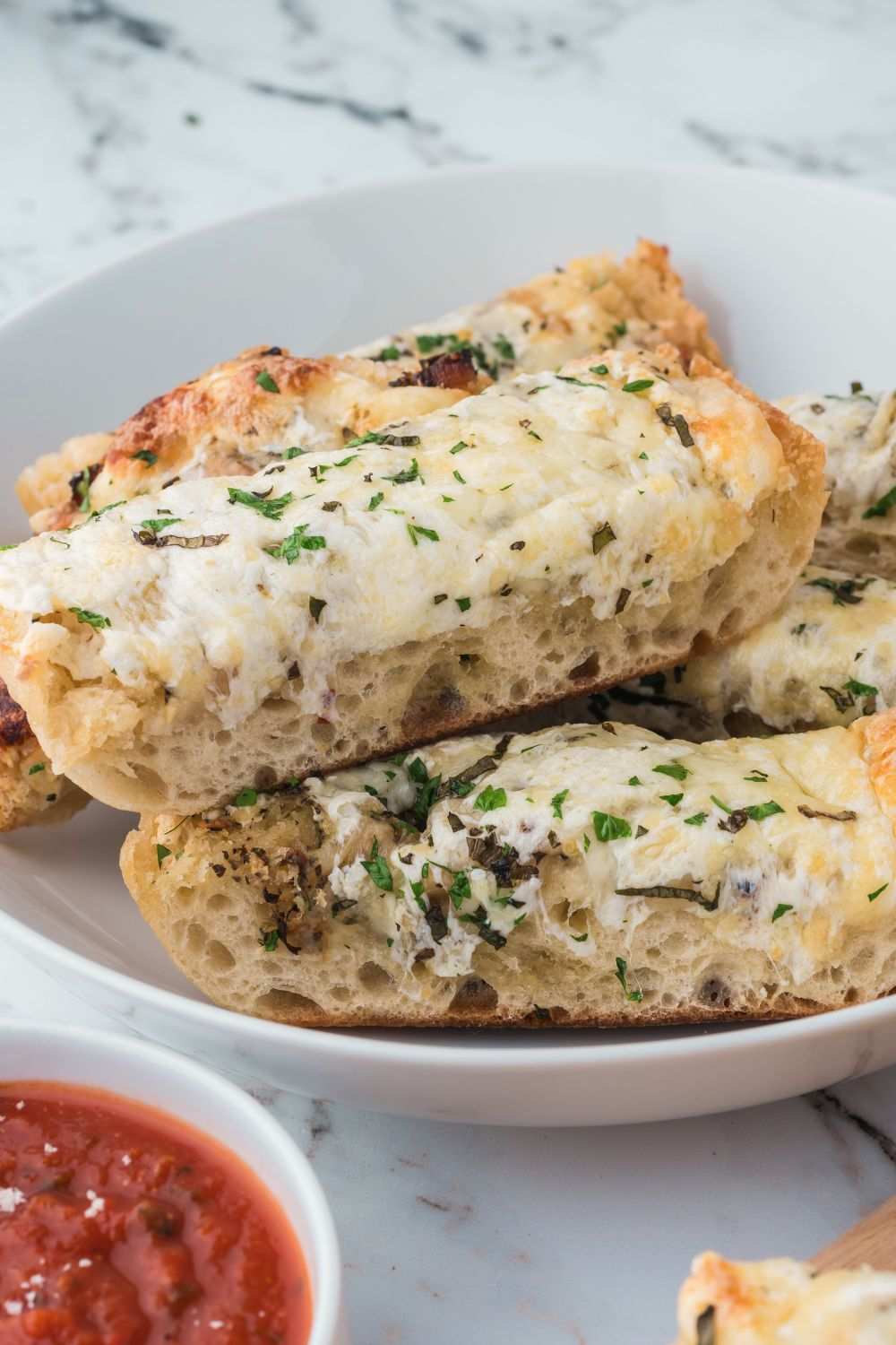 Cheesy garlic bread with golden crust, melted mozzarella, garlic butter, and fresh parsley