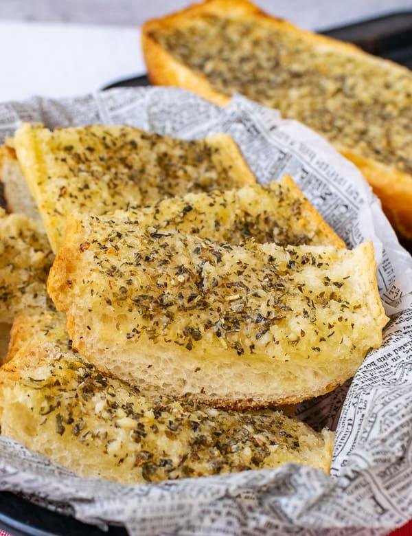 Classic garlic bread with herbed butter, golden crust, and a sprinkle of fresh thyme