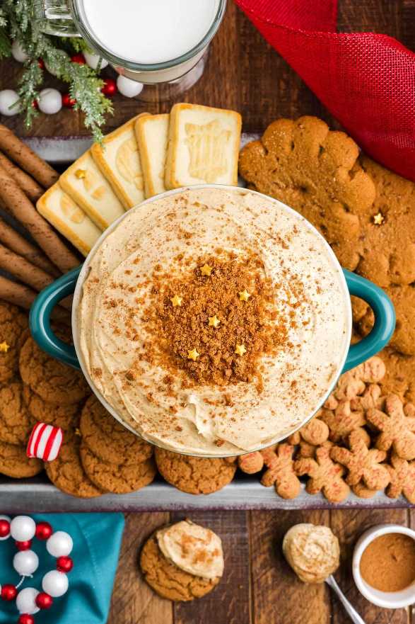 White creamy dip in a bowl with gingerbread cookies for dipping.