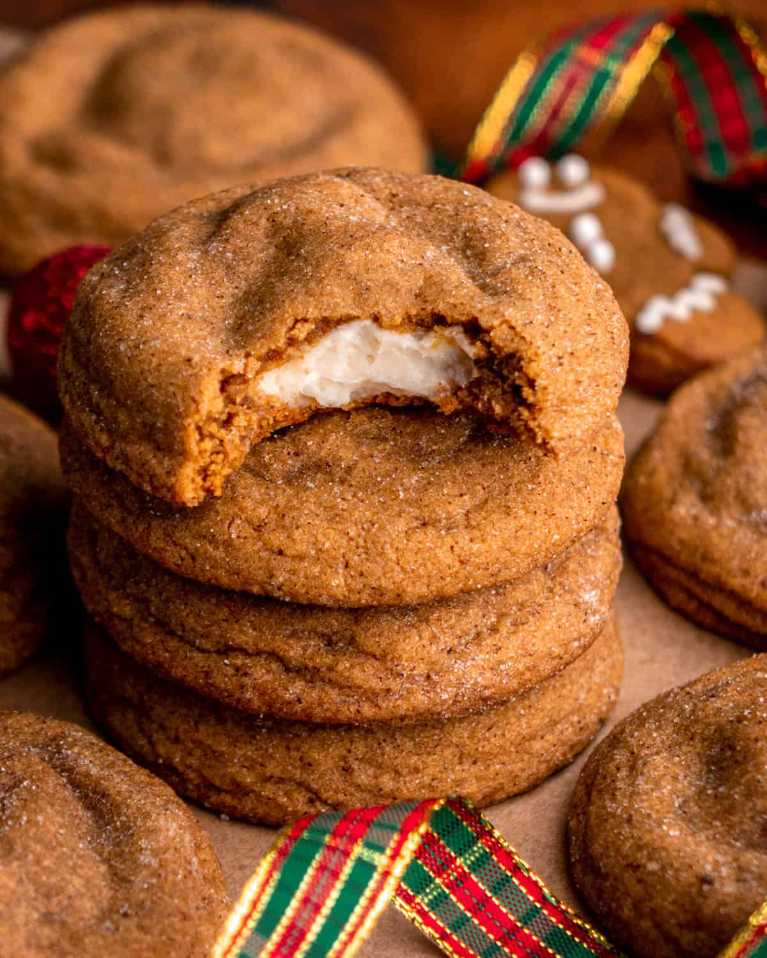 Cross-section of a gingerbread cookie revealing a white cheesecake center.