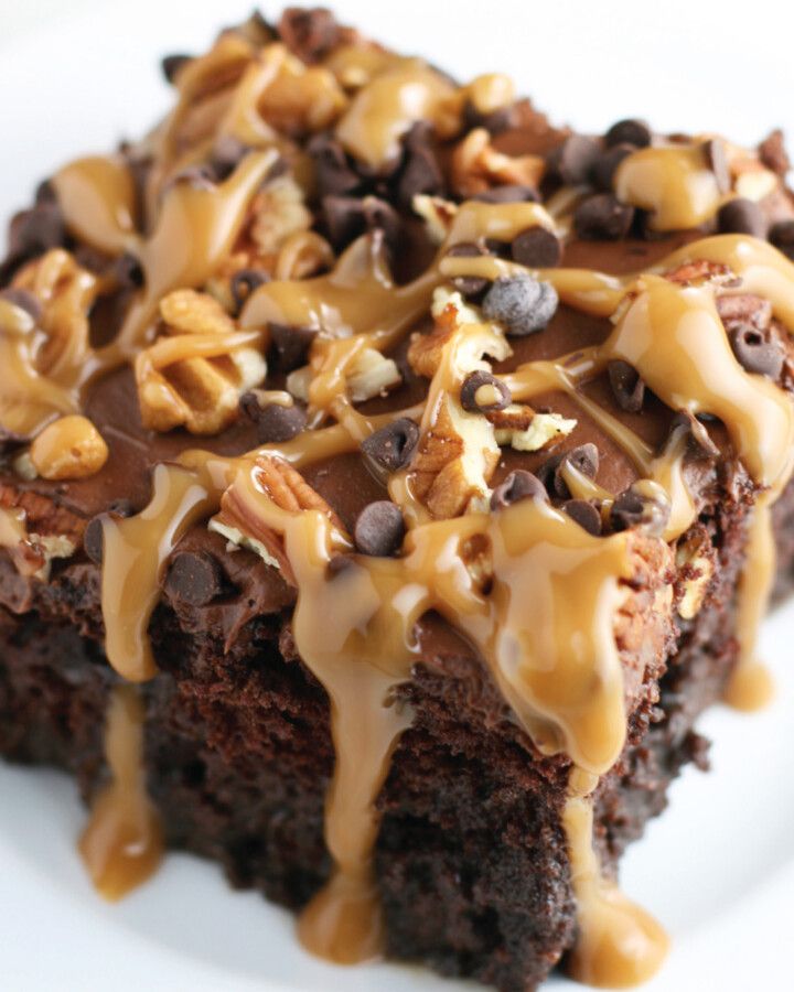 Layered poke cake with chocolate and caramel layers.