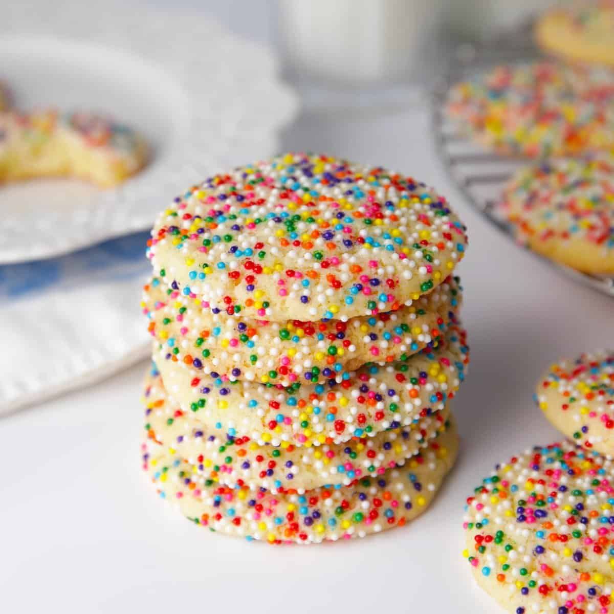 Round sugar cookies with colorful sprinkles and a white glaze.