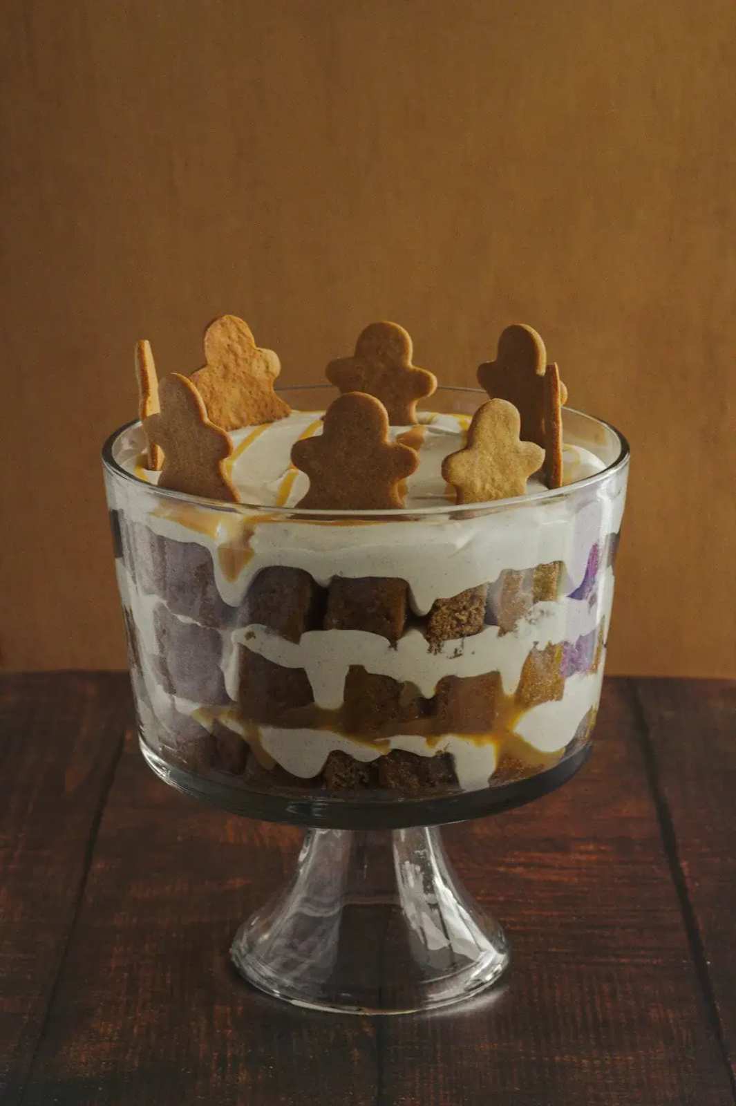 Layered trifle with sponge, cream, and fruit.