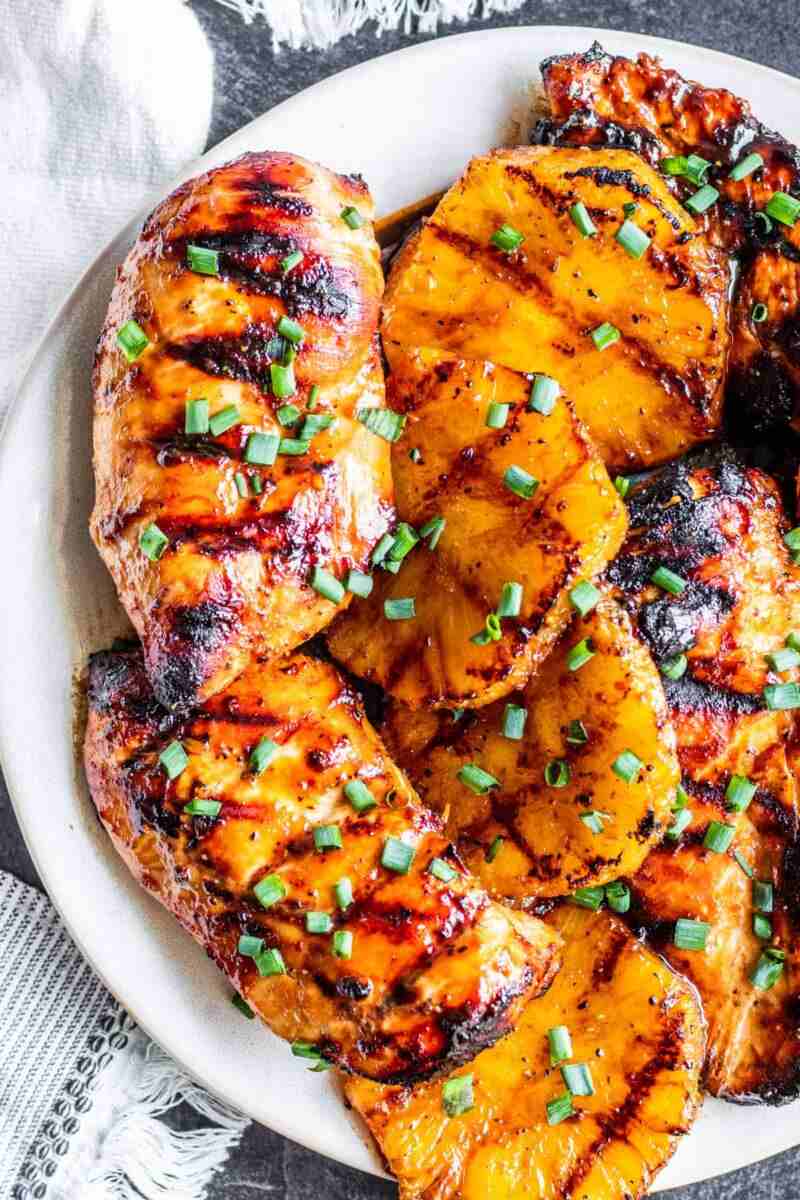 Grilled pineapple chicken with crisp broccoli, tangy dressing, toasted nuts, dried fruit, and cheese.
