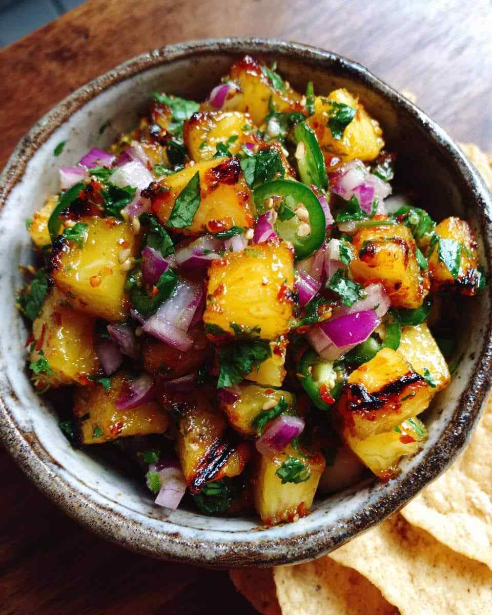 Grilled pineapple salsa with crisp broccoli, tangy dressing, toasted nuts, dried fruit, and cheese.