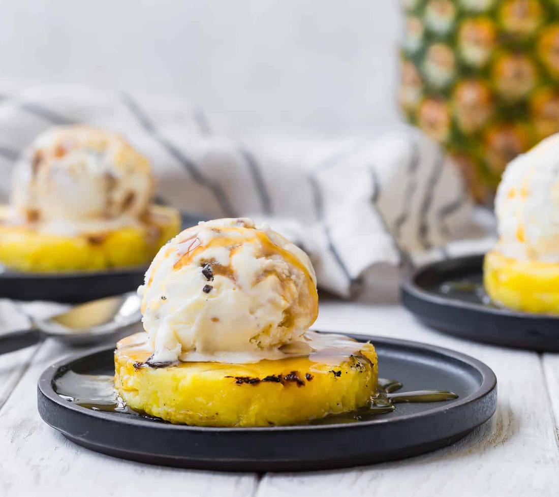 Grilled pineapple with vanilla ice cream, crisp broccoli florets, dressing, toasted nuts, dried fruit, cheese