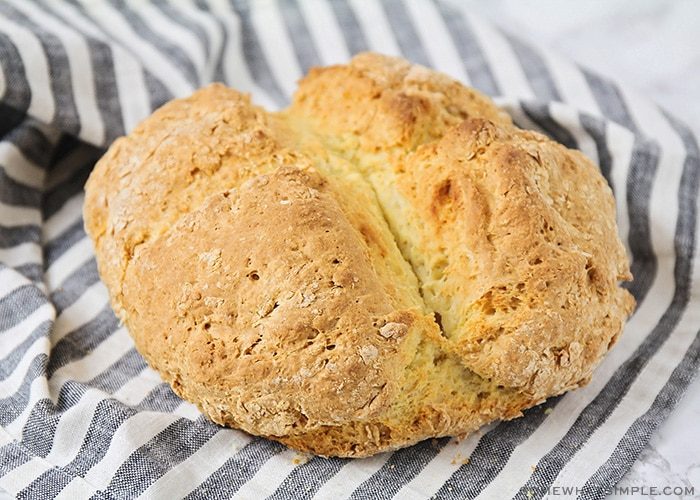 Golden‑crusted classic Irish soda bread loaf with a deep scored cross