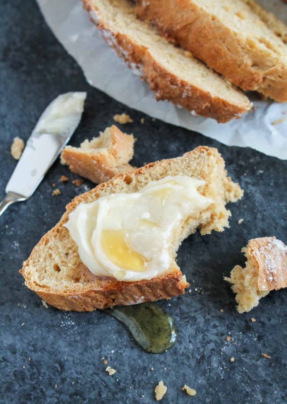 Golden Irish soda bread loaf served with a drizzle of honey butter, glossy and inviting