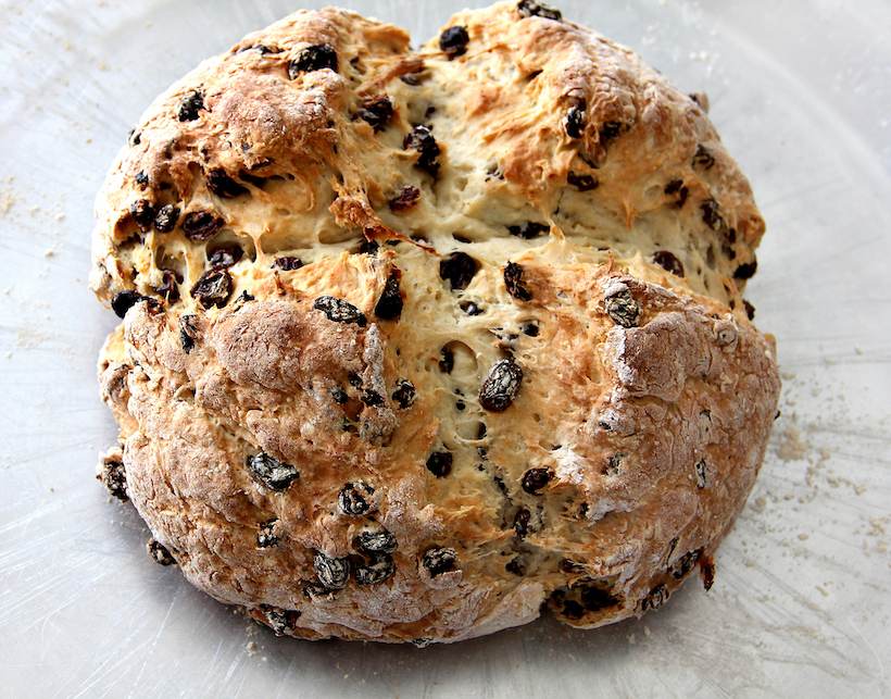 Traditional Irish soda bread baked in quadrants, golden crust and tender sections