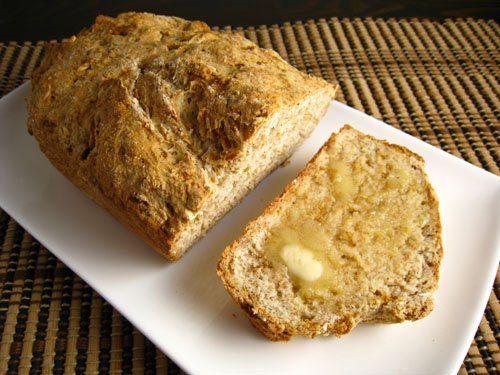 Golden‑crusted sliced Irish soda bread with tender crumb and rustic edges