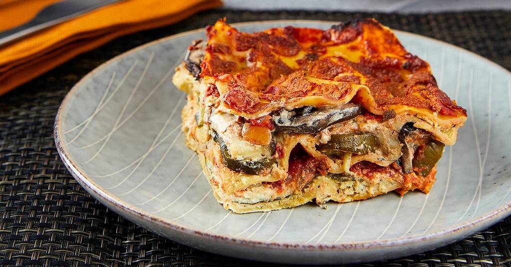 Earthy mushroom‑spinach layers, creamy ricotta, and melted mozzarella atop golden pasta sheets.