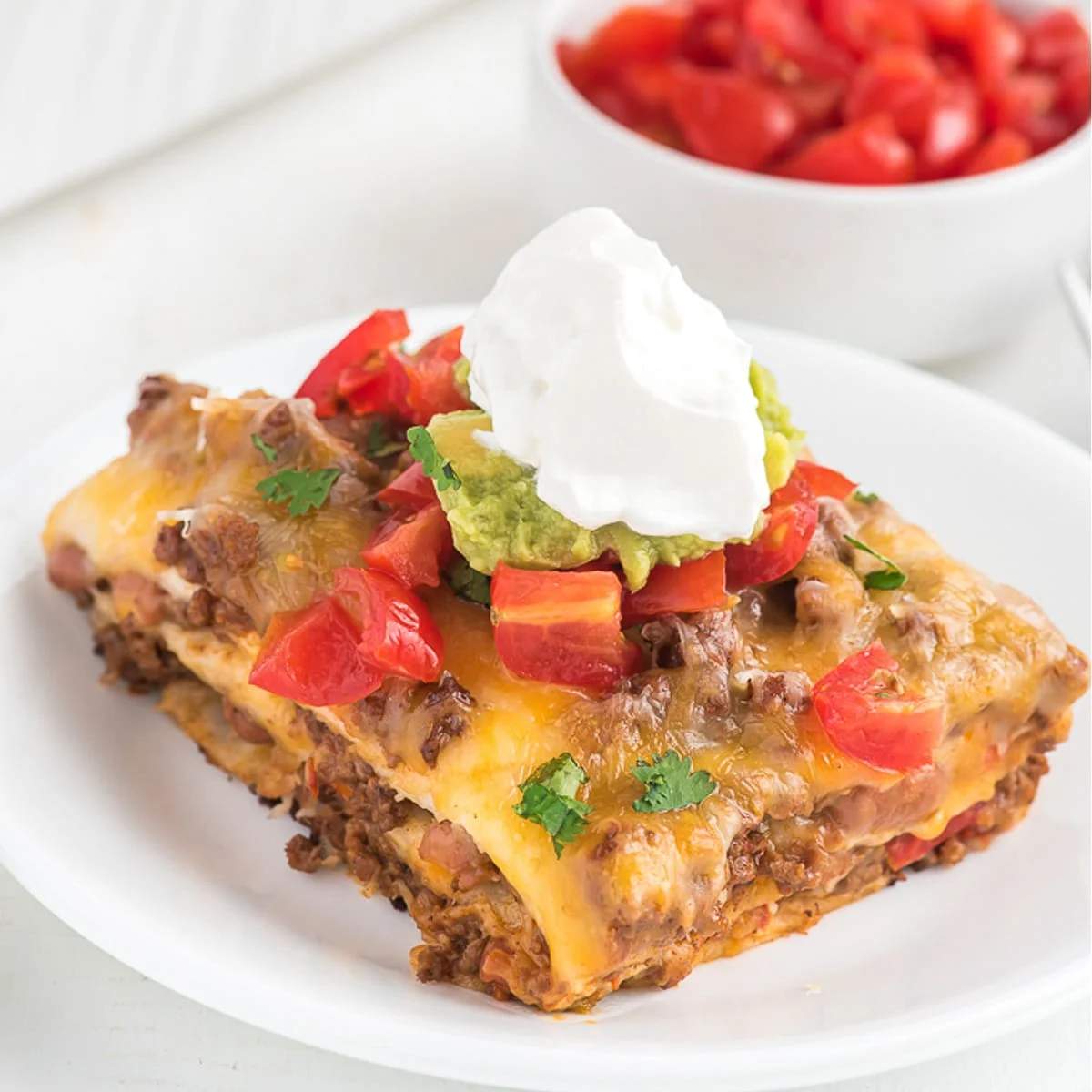 Taco‑seasoned beef, corn, and cheese layer in a lasagna, topped with melted jalapeño cheddar.