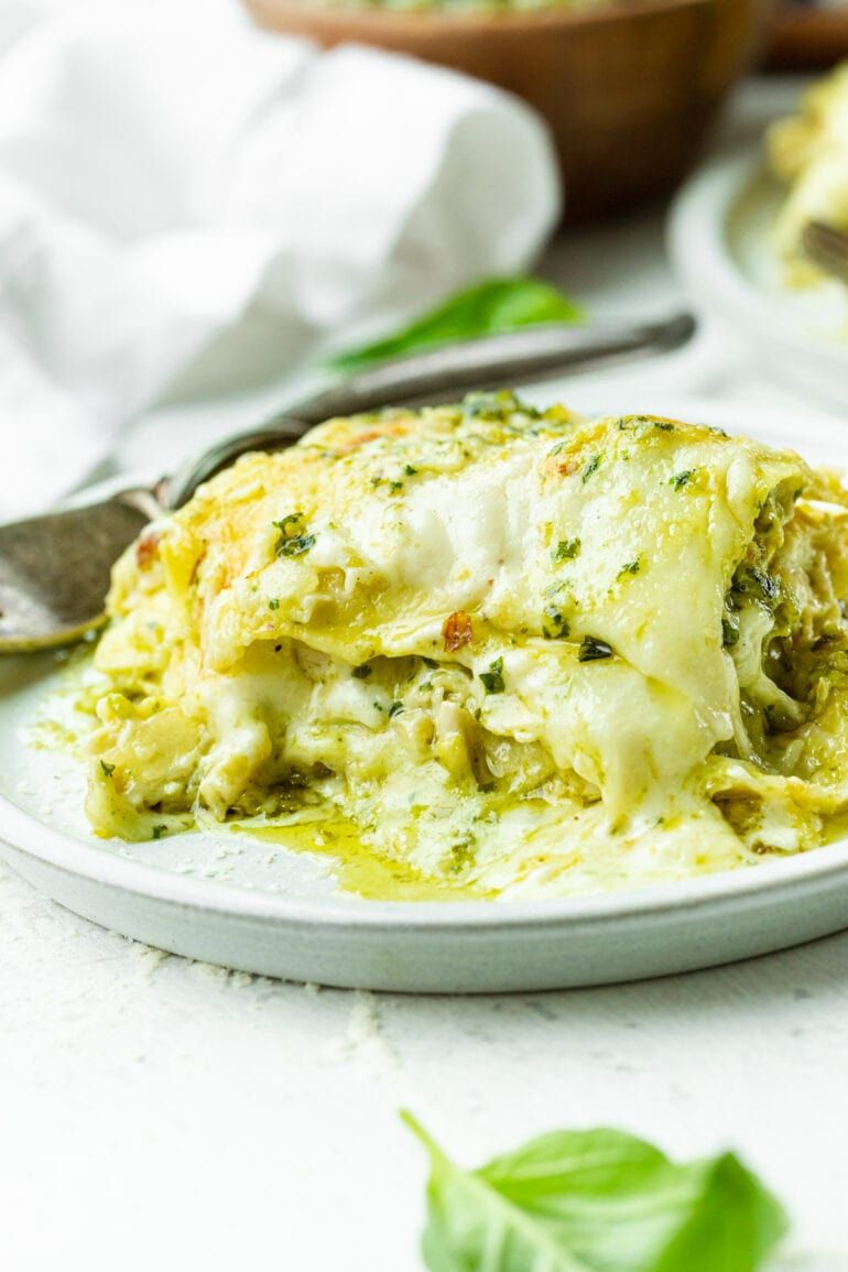 Pesto chicken lasagna layered with spinach, mozzarella, and creamy ricotta cheese