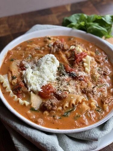 Steaming lasagna soup brimming with tender noodles, rich tomato broth, and bubbling golden cheese