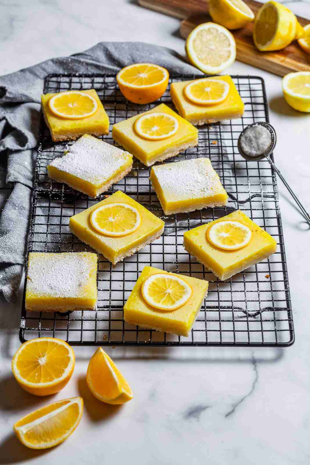 Meyer lemon bars featuring buttery crust, mellow lemon curd, and powdered sugar dusting