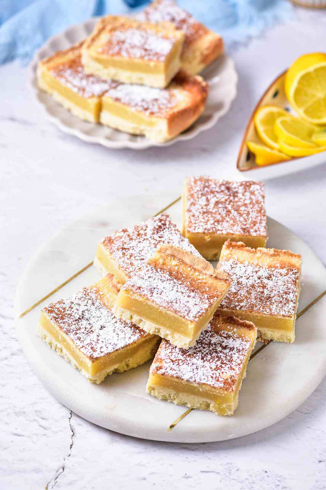 Classic lemon bars with golden shortbread crust, bright lemon curd, dusted with powdered sugar