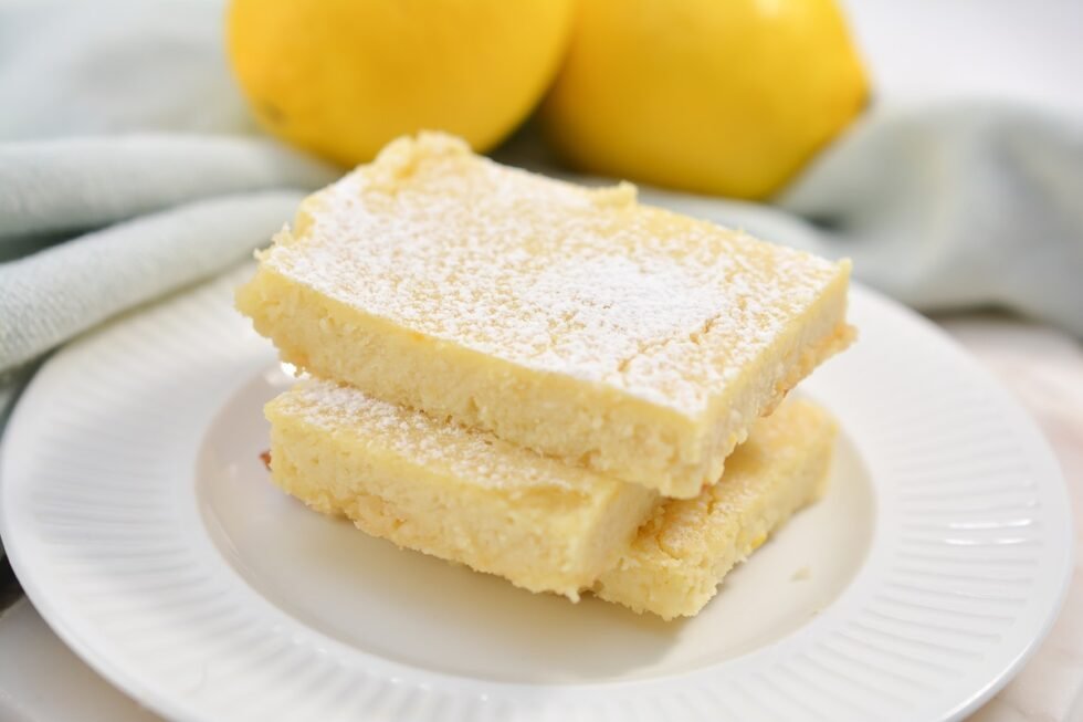 Classic lemon bars with golden shortbread crust, bright lemon curd, dusted with powdered sugar