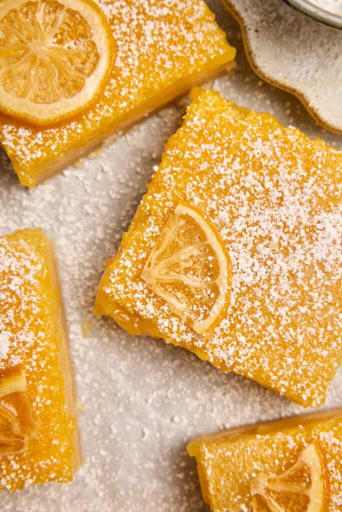 Classic lemon bars with golden shortbread crust, bright lemon curd, dusted with powdered sugar
