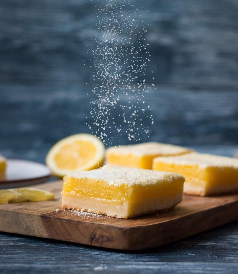 Buttery shortbread base, vivid lemon curd, dusted with fine powdered sugar