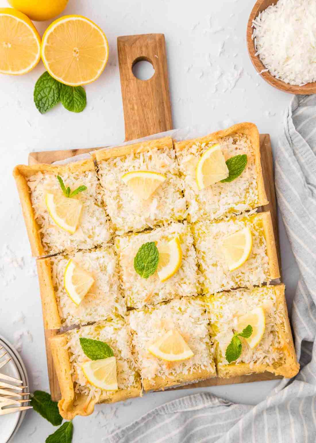 Lemon coconut bars with golden lime‑infused shortbread crust, bright lemon curd, coconut flakes dusting