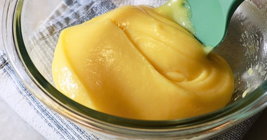 Simple 4‑ingredient lemon curd in a small pot, bright yellow, smooth, with lemon slice garnish