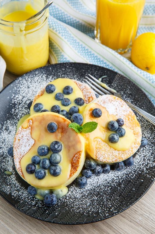 Puffy Japanese souffle pancakes layered with lemon curd and fresh blueberries